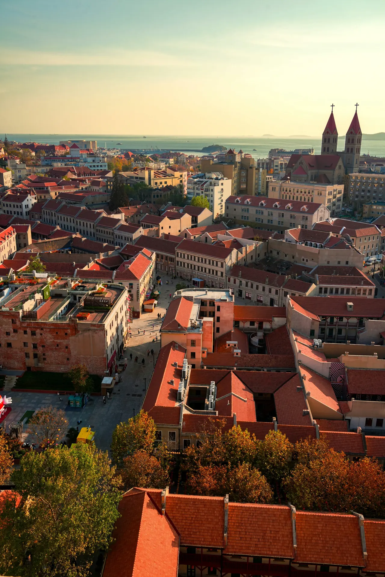 An aerial view of a city with red roofs