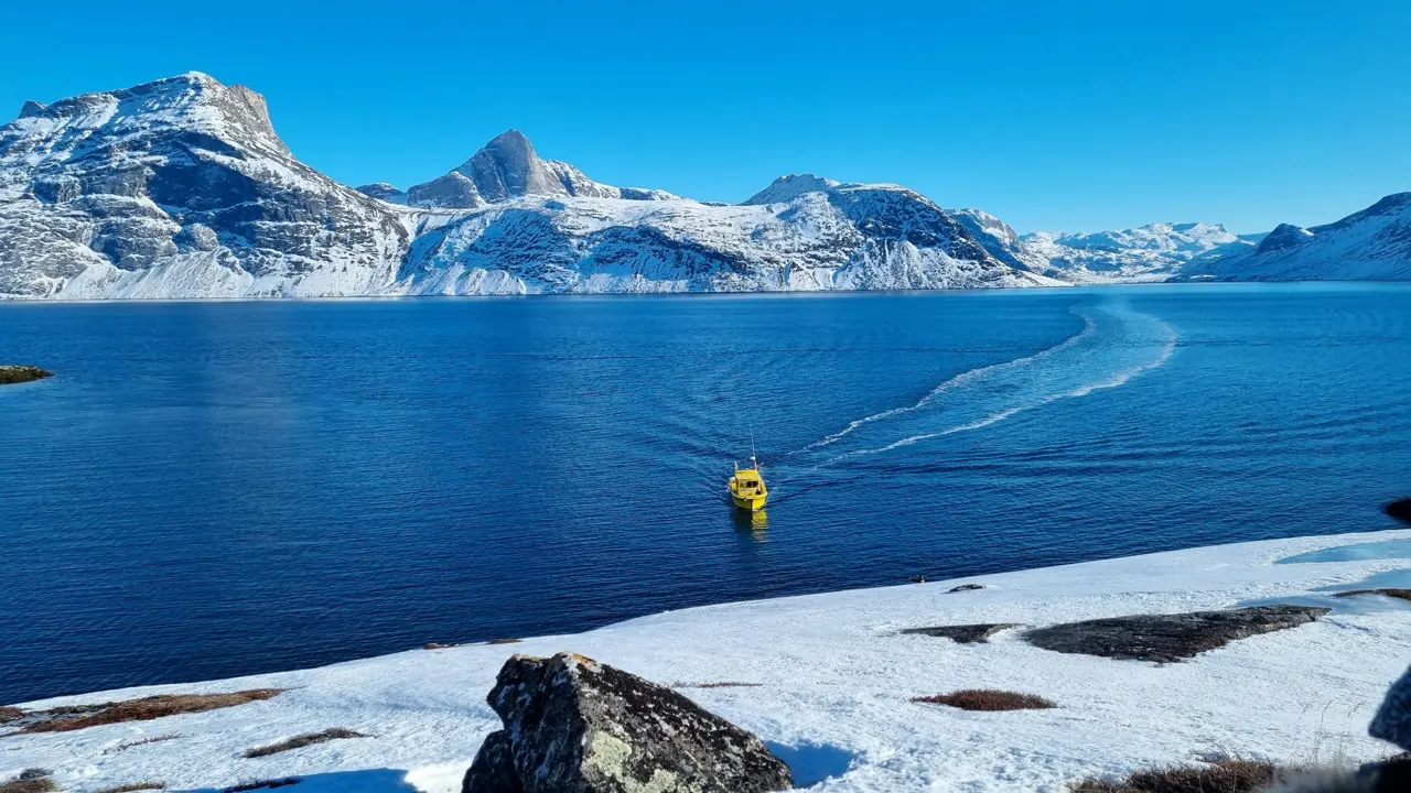 a man in a yellow life jacket is in the water