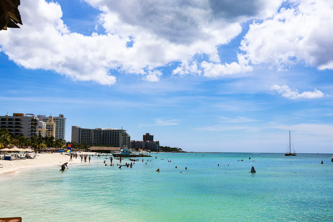 People enjoying a sunny day at a tropical beach resort