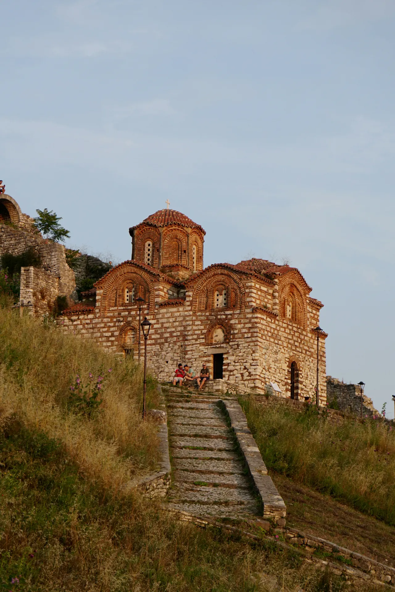 Capture the timeless beauty of Berat Castle in Albania with this stunning photo of a Greek Orthodox church nestled within its ancient walls