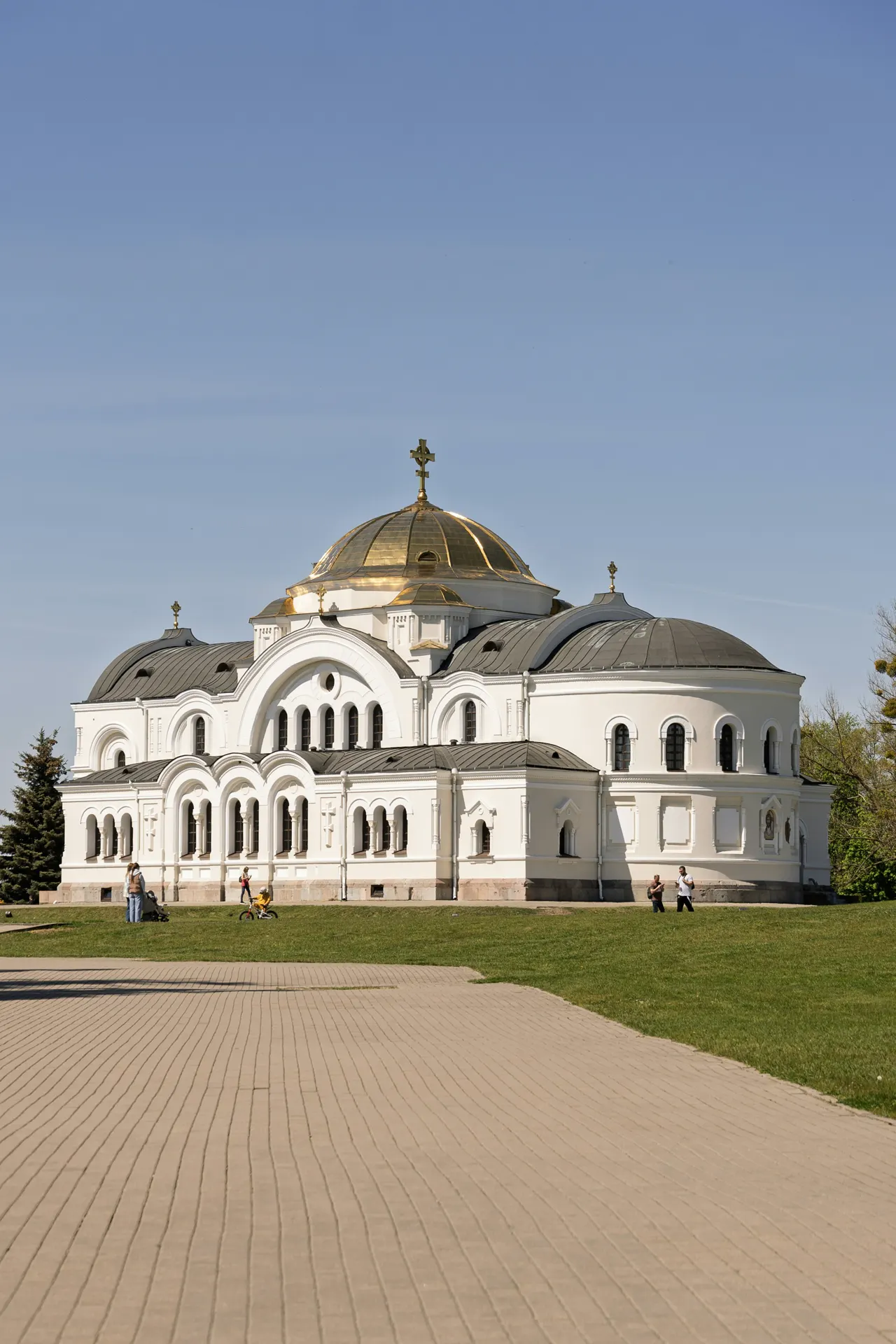 Grand white church with golden dome under blue sky