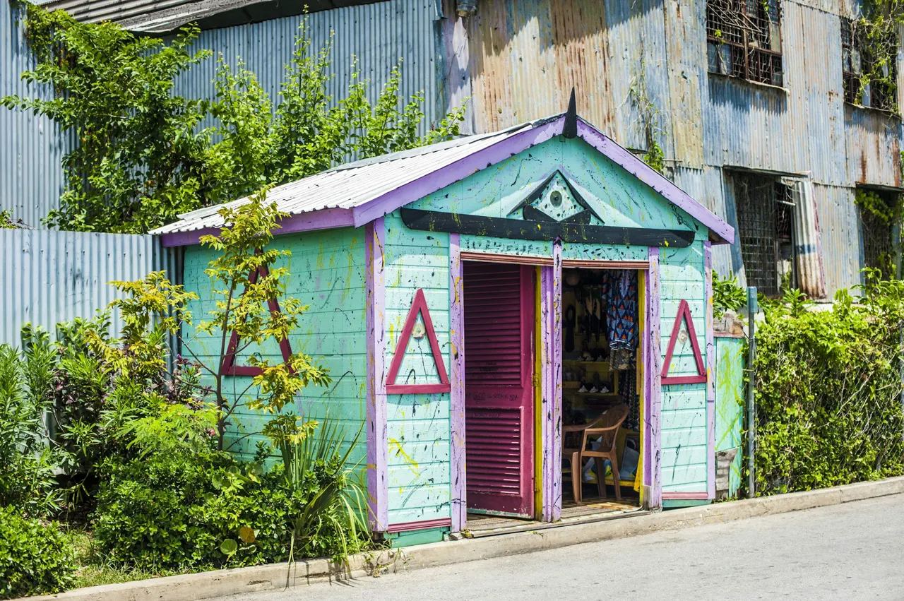 a blue building with a purple door and window