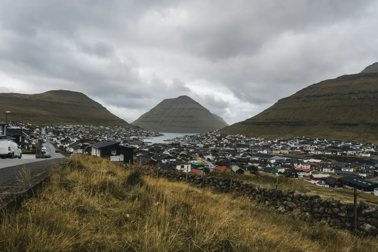 a view of a town with mountains in the background