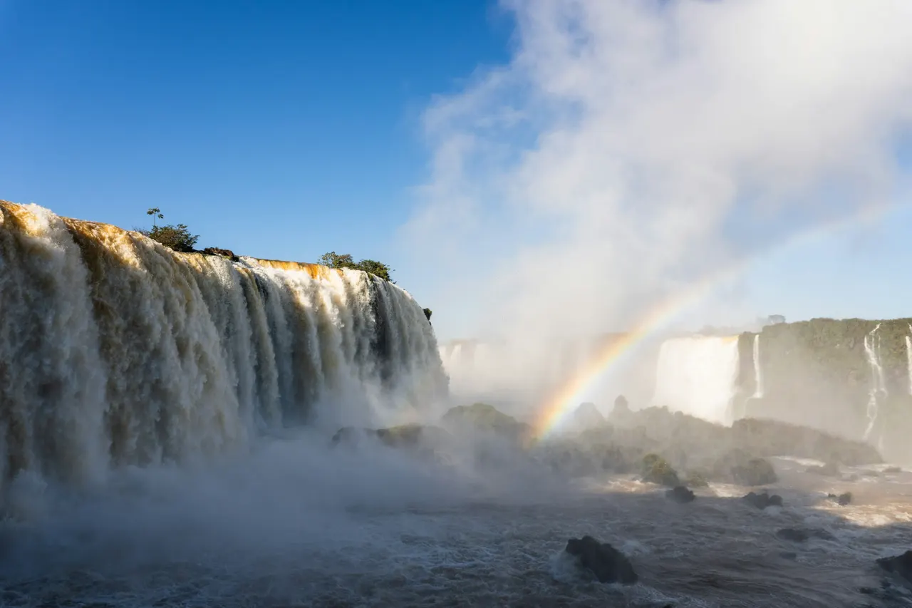 Dramatic waterfall with a vivid rainbow