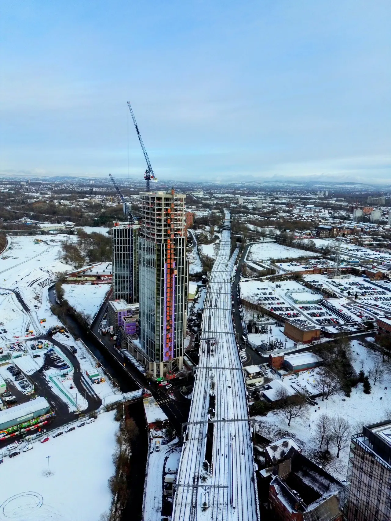 Drone of tram/train tracks in snow in Manchester